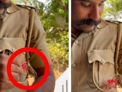 Полицейский угостил цветочком птичку, усевшуюся на его униформу